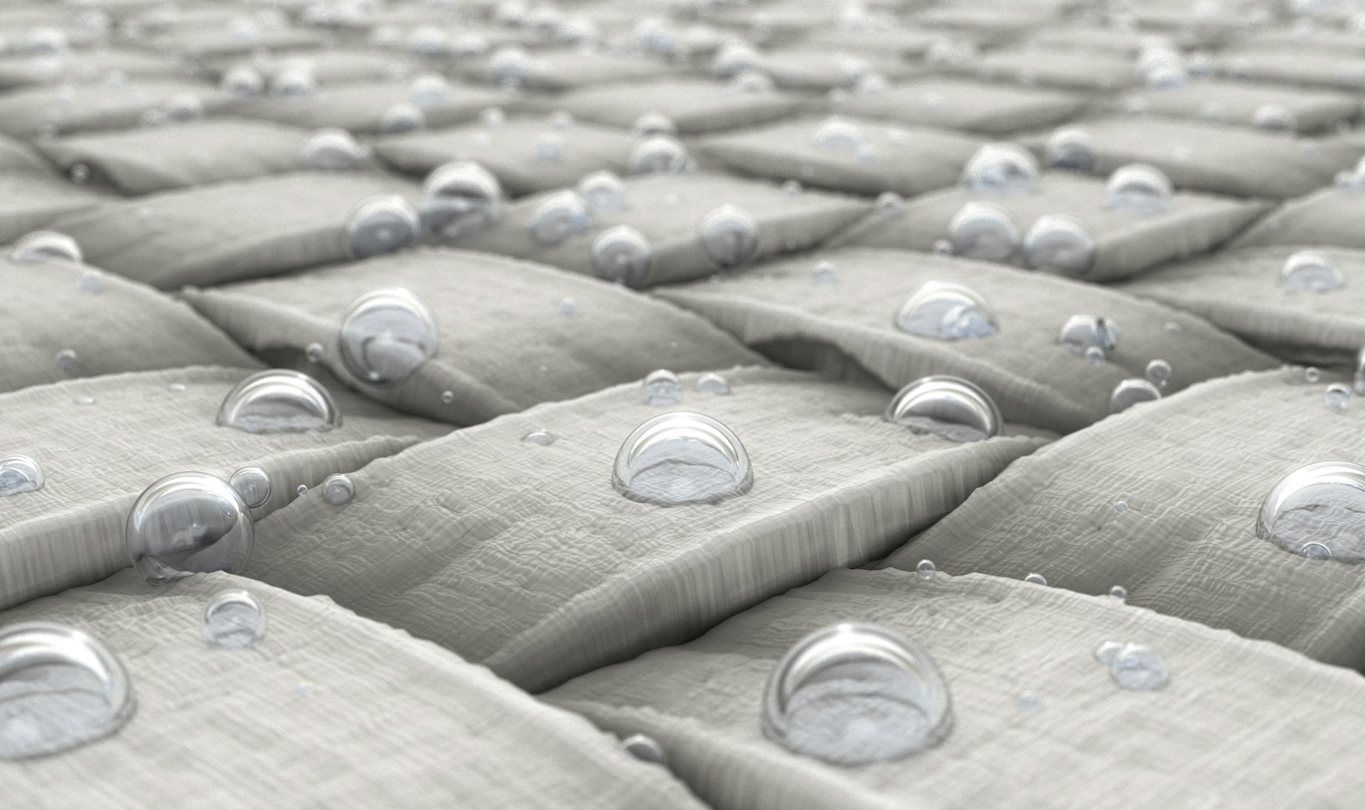 Water droplets beading on treated fabric