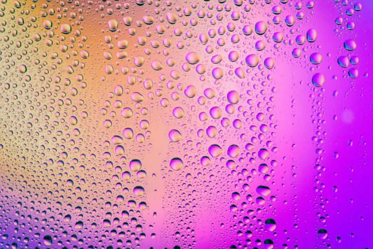 Water droplets beading on a pane of glass